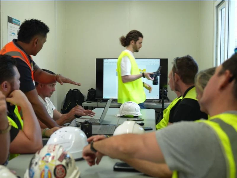 Traffic management team attending training and site planning meeting in office environment