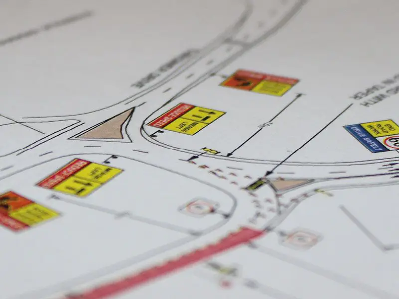 Traffic management consultants reviewing roadwork planning documents